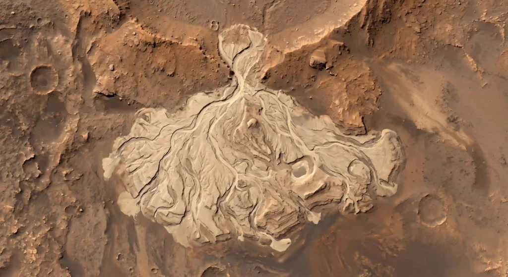 Orbital view of an ancient dried river delta in a Martian crater, proving the planet once had flowing liquid water.